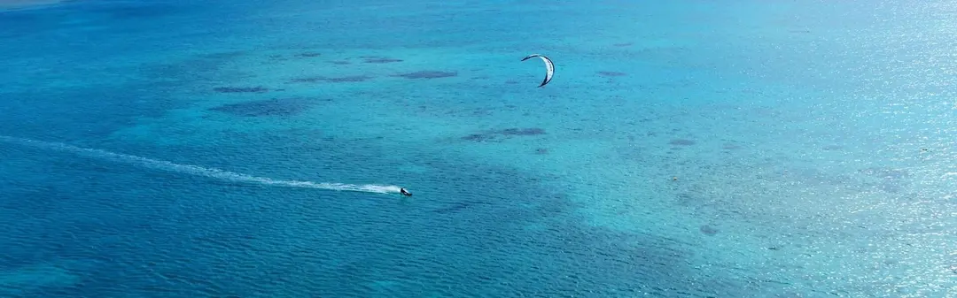Kite-surfing on the turquoise lagoon off Somabay